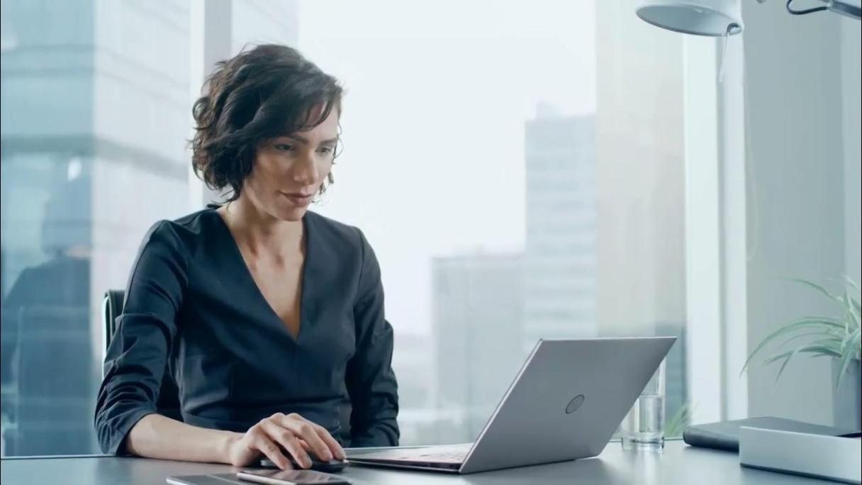 Instructor working one-on-one with a learner reviewing financial growth data on screen